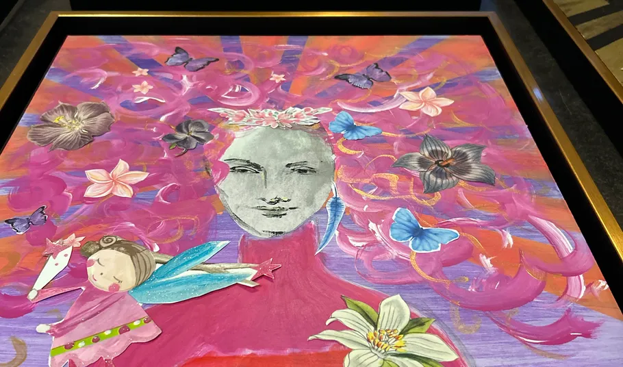 Colorful artwork with butterflies, flowers, and abstract face.