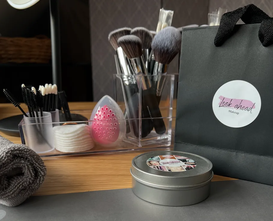 Makeup brushes and tools on wooden table.