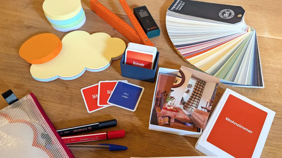 Design tools, cards, color samples on table.
