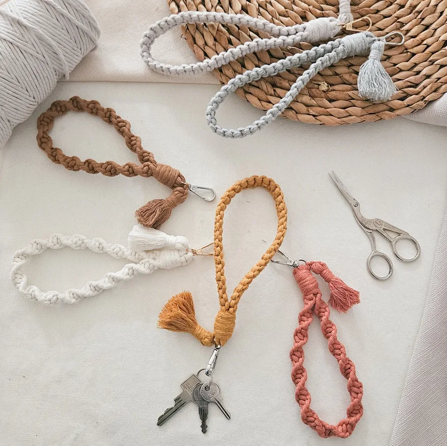 Colorful macrame keychains displayed on a table.