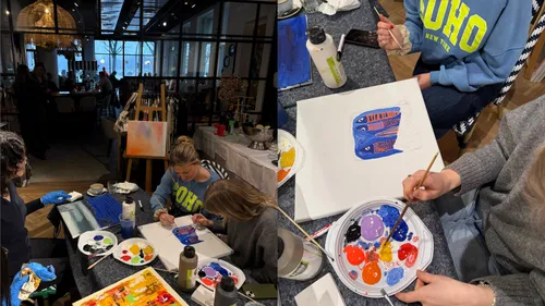 People painting in a lively indoor setting.