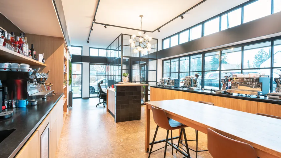 Modern café interior with large windows.