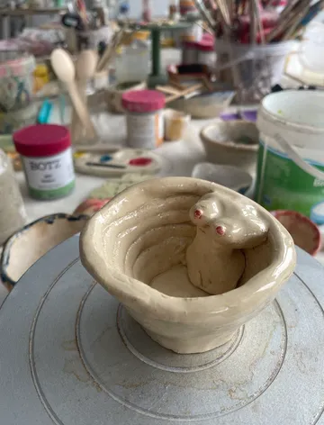 Ceramic bowl with animal shape inside studio.
