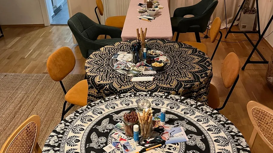 Tables with art supplies in a cozy room.