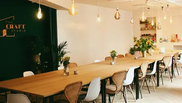 Long table with chairs in creative studio.