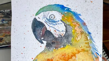 Colorful parrot painted on textured paper.