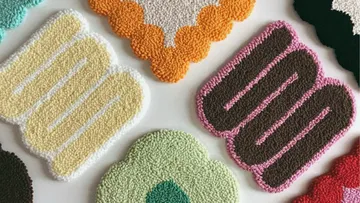 Colorful, textured fabric swatches on a white surface.