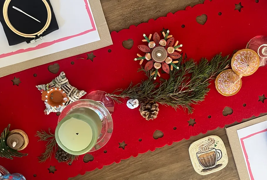 Festive table setup with red runner and candles.