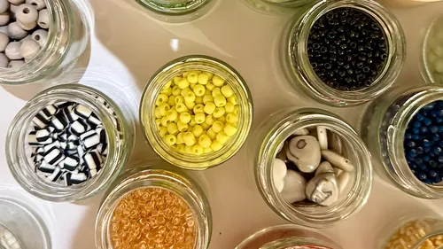 Glass jars filled with colorful beads.