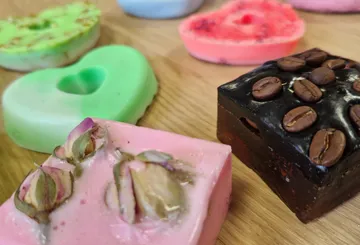Colorful soap bars with decorative elements displayed.