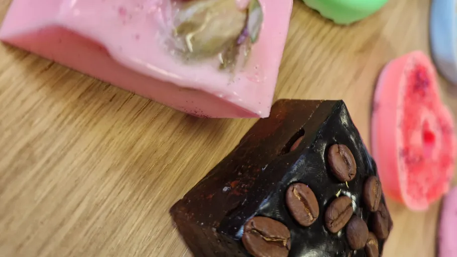 Colorful soap bars with decorative elements displayed.