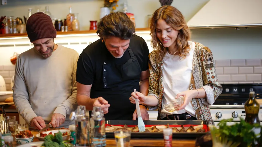 Three people cooking in a kitchen together.