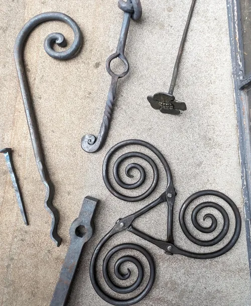 Metal spiral designs on a flat surface.
