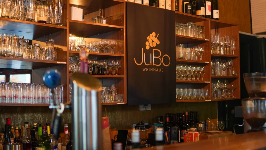 Wine bar with shelves of glasses.
