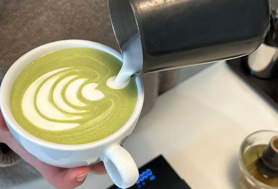 Cup of matcha latte with latte art.