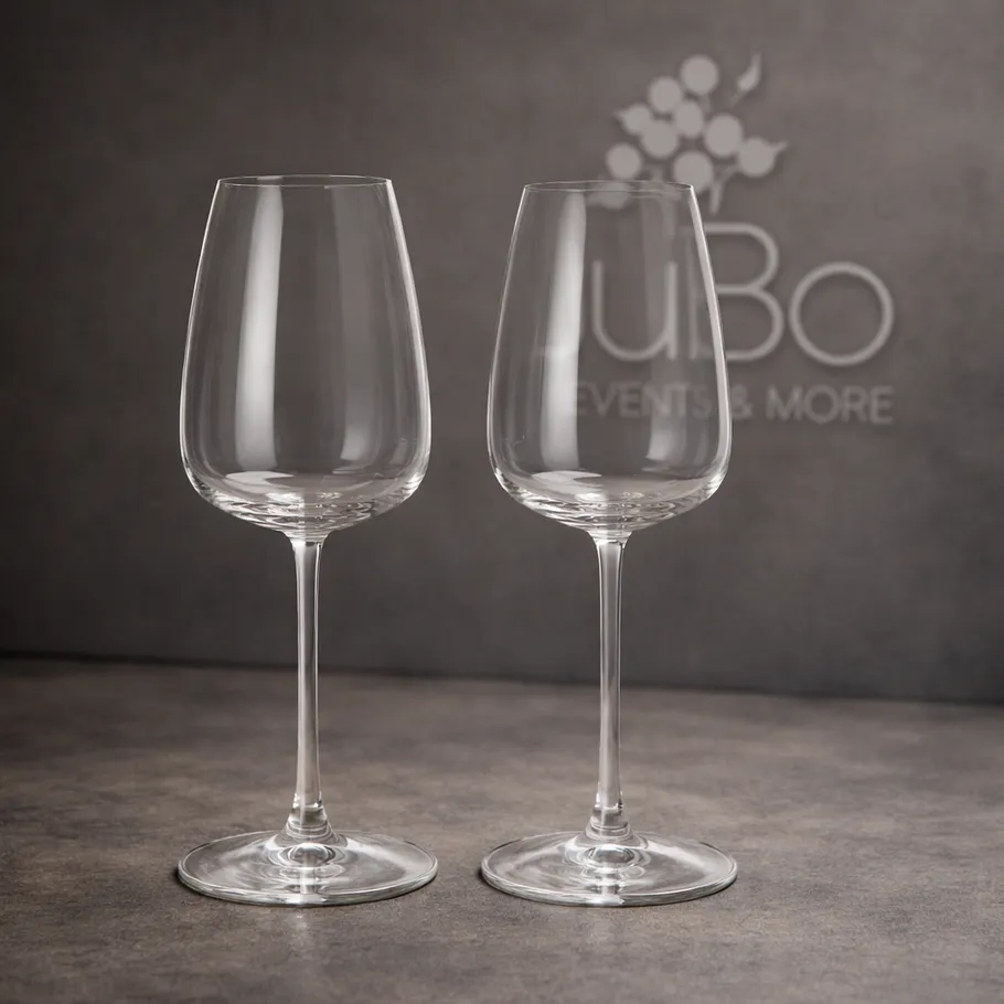 Two empty wine glasses on a table.