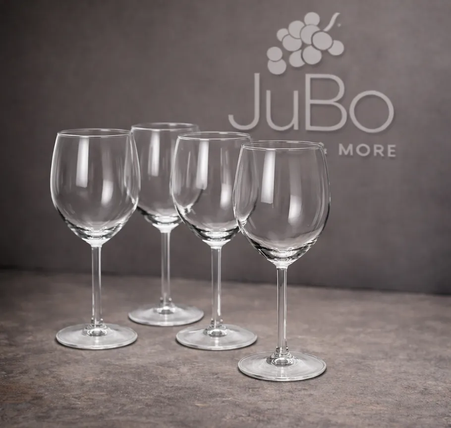 Four wine glasses on gray surface.