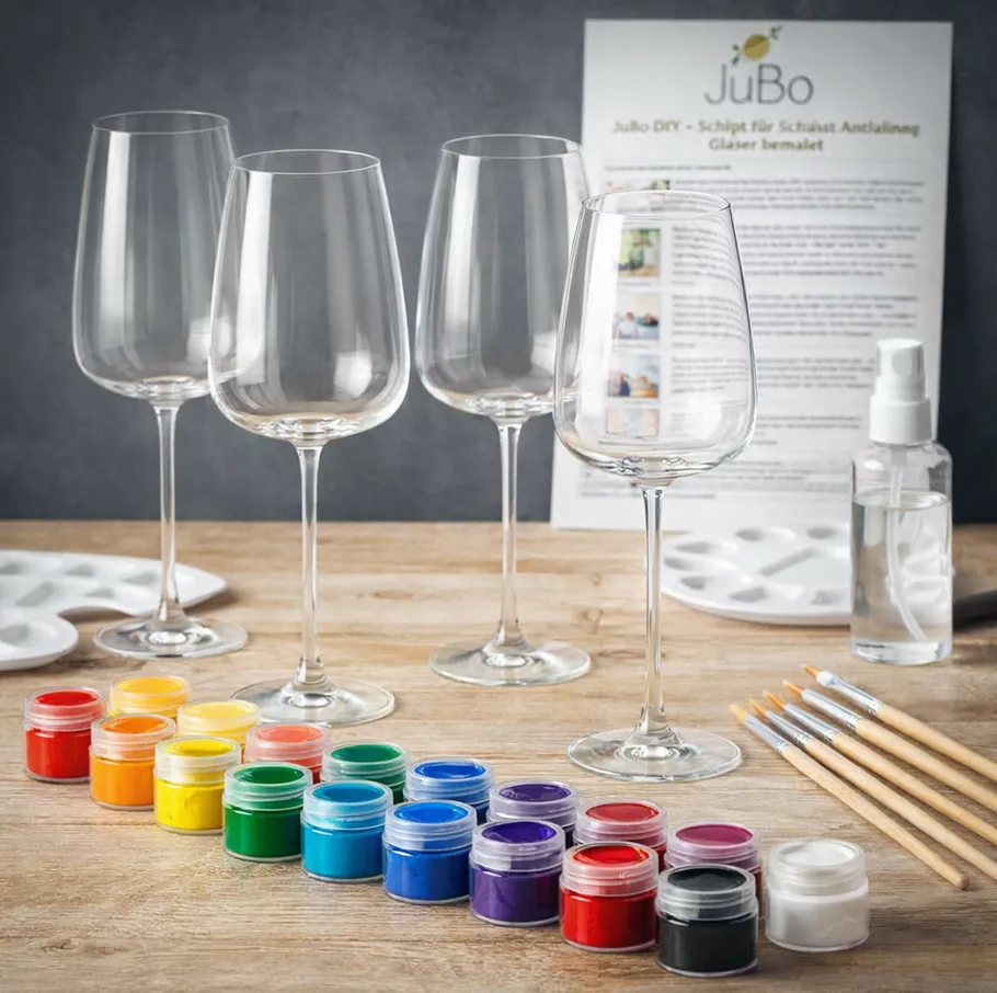 Paint set with brushes and empty wine glasses.
