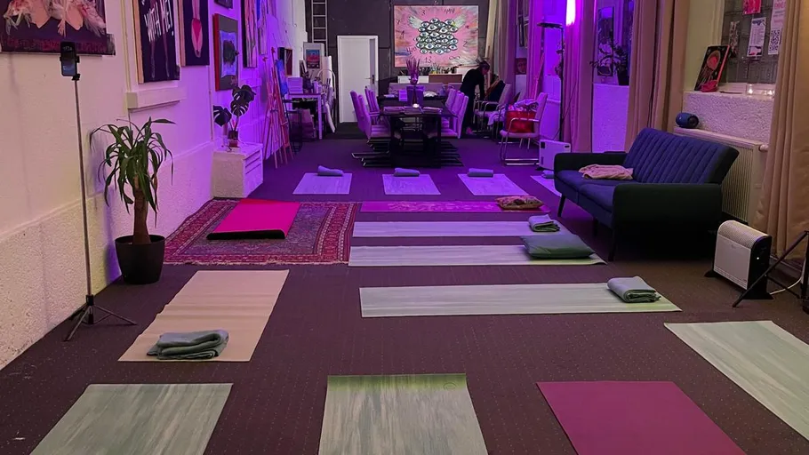 Yoga studio with mats and ambient lighting.