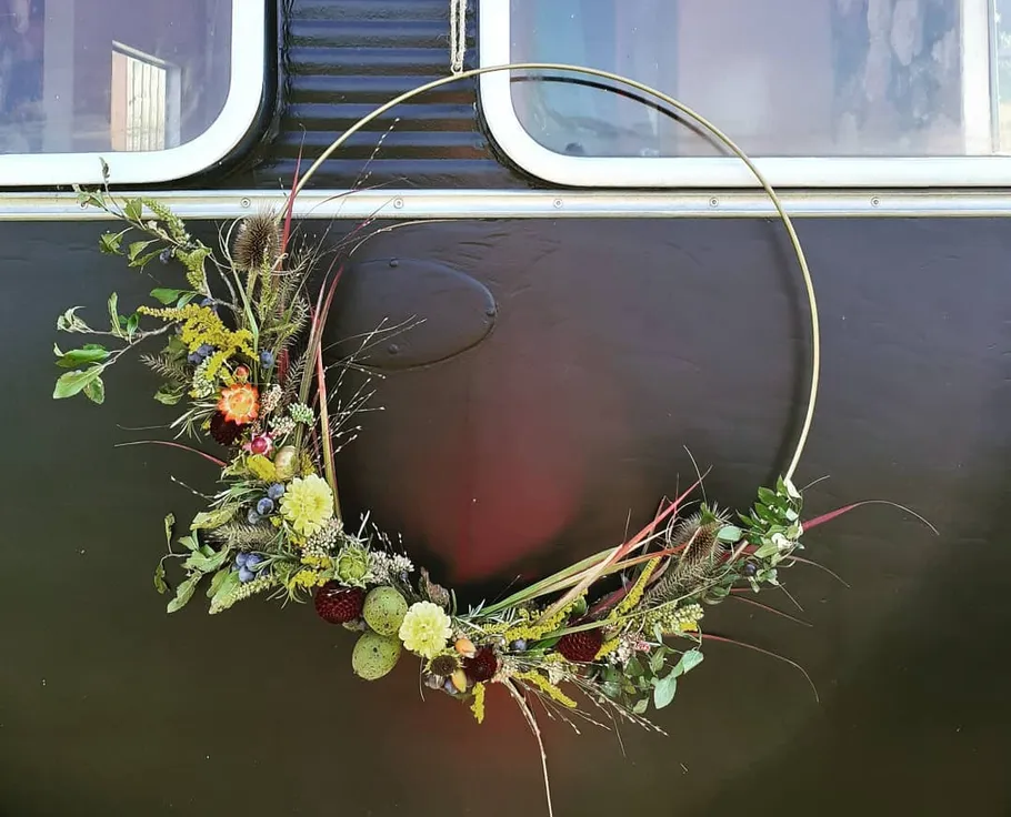 Decorative wreath hanging on a dark wall.