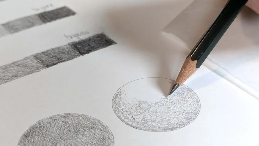 Pencil shading circles on white paper.
