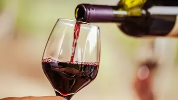 Red wine pouring into a glass.