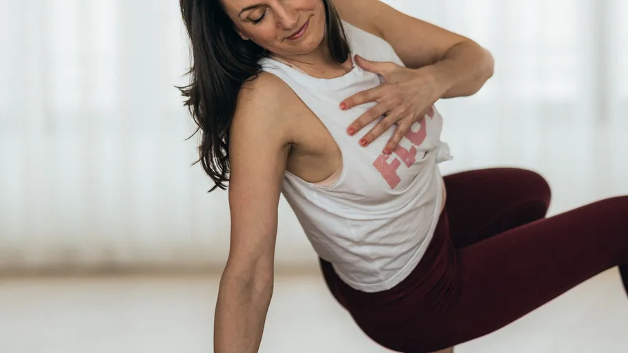 Woman doing yoga pose indoors.