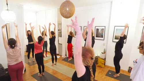 People practicing yoga in a bright room.