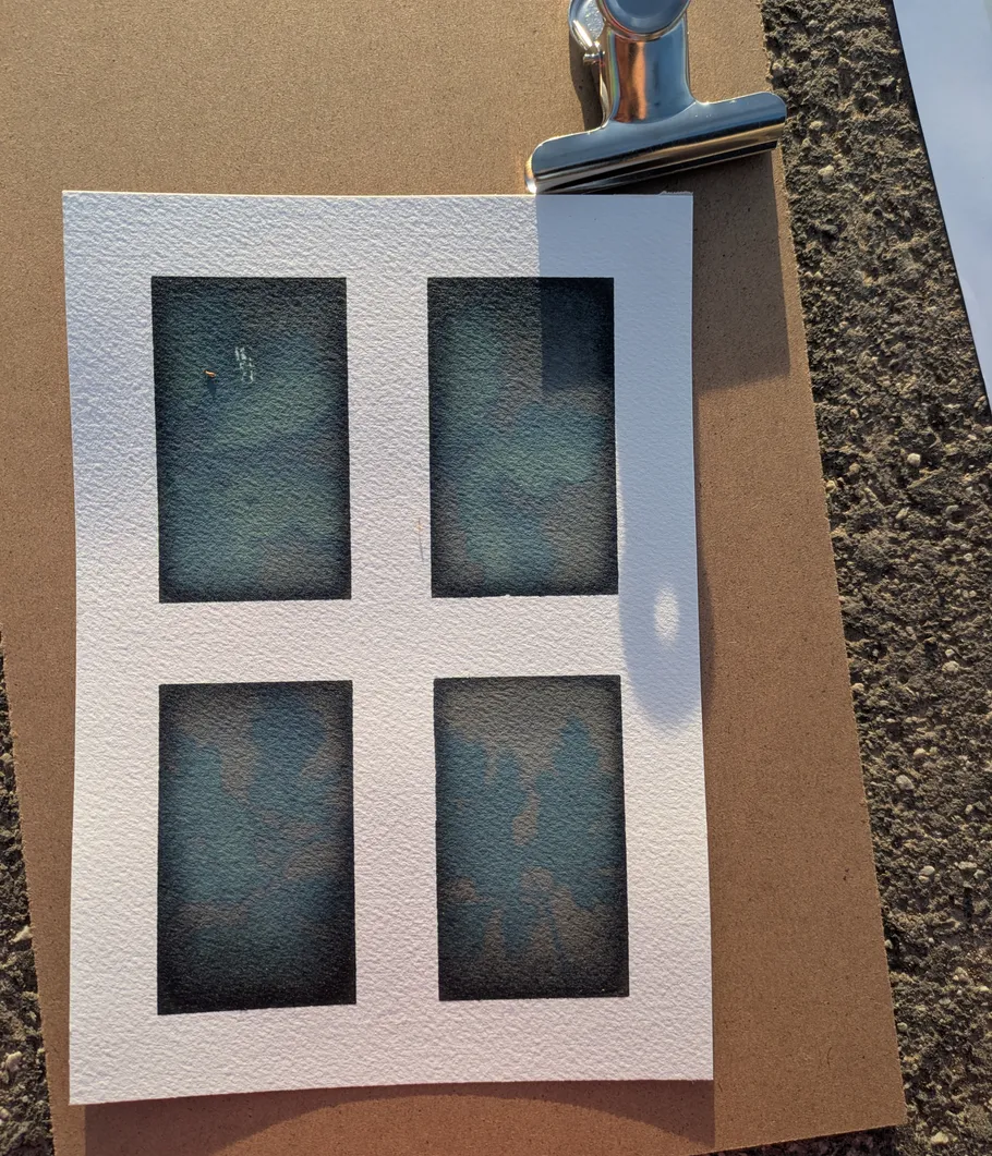 Four blue rectangles on paper with clip.