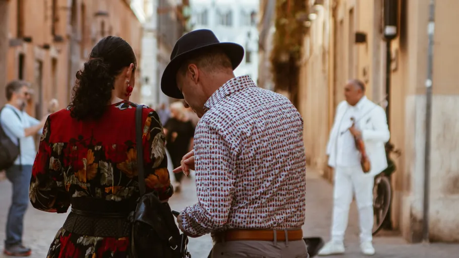 Two people walking in a narrow street.