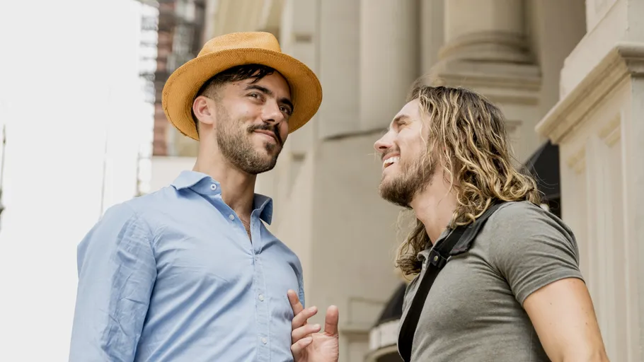Two men talking on a city street.