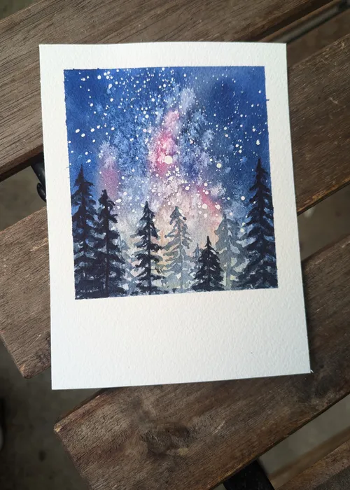Watercolor painting of starry night over trees.