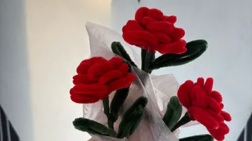 Red felt roses wrapped in paper bouquet.