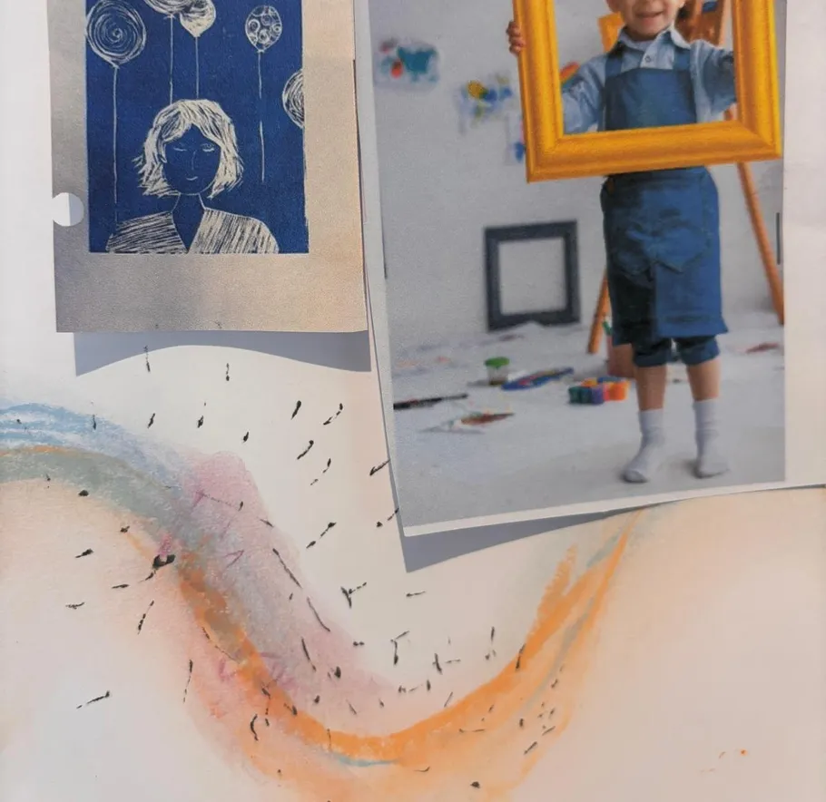 Child holding frame, art studio setting.