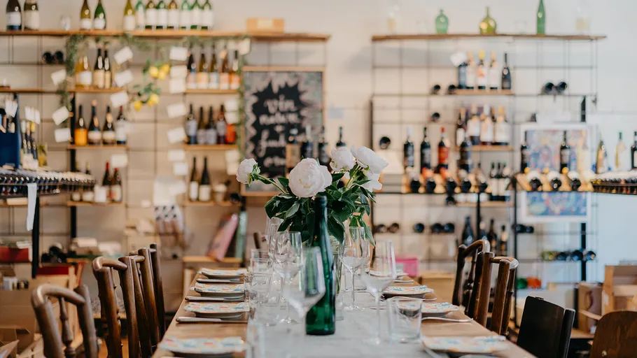 Elegant dining setup in wine shop.
