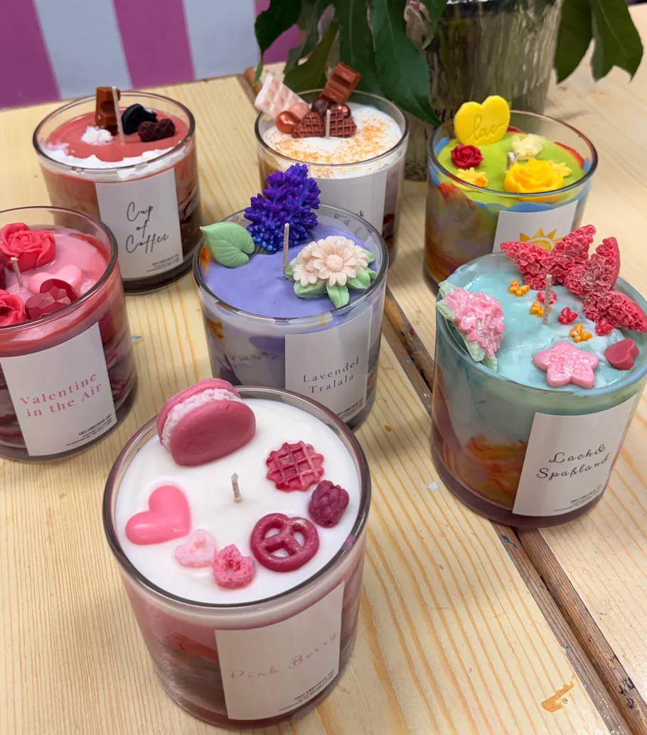Colorful decorative candles on a wooden table.