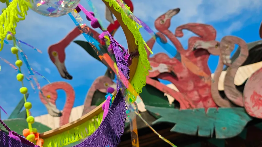 Colorful decorations with flamingo cutouts outdoors.