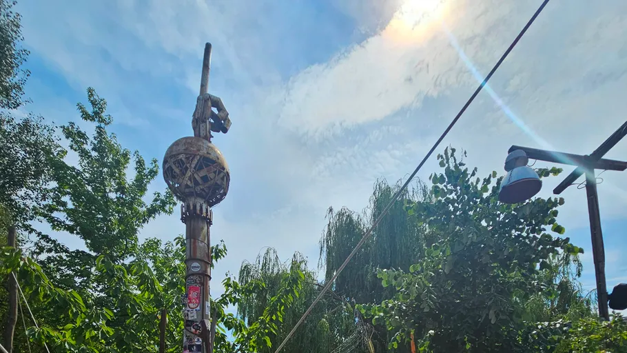 Totem pole with decorations under clear sky.