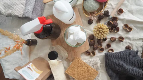 Various cleaning products arranged on fabric.