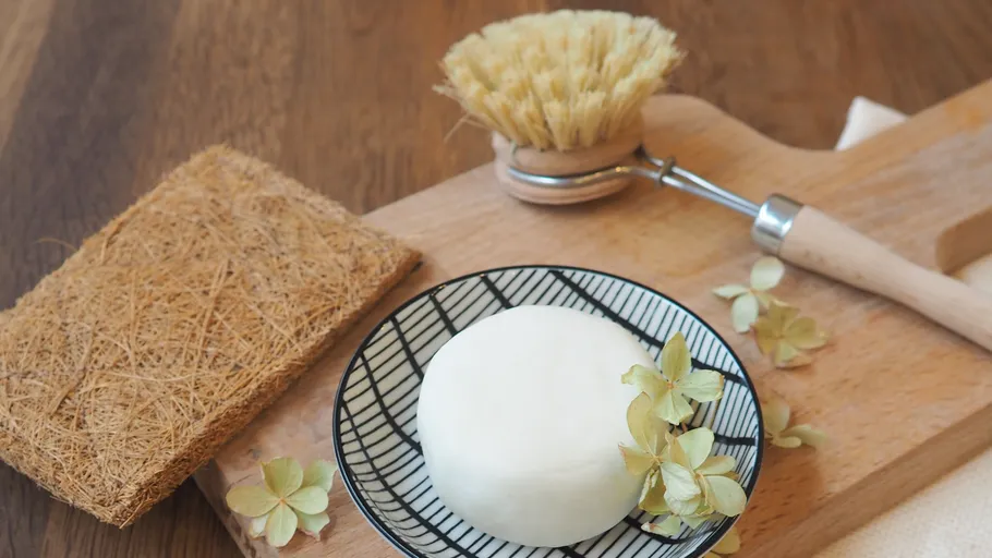 Soap and brush on a wooden board.