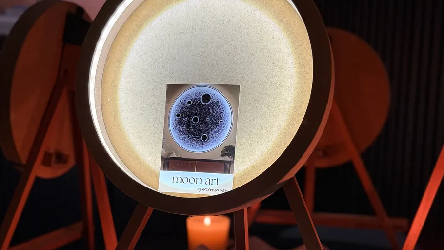 Glowing drum with moon art card inside.