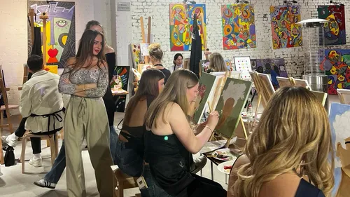 People painting in an art studio setting.