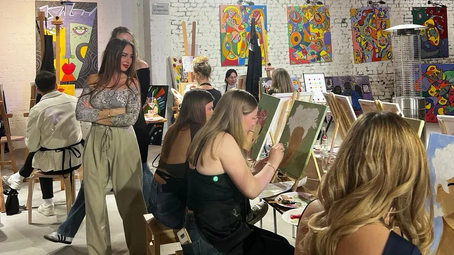 People painting in an art studio setting.