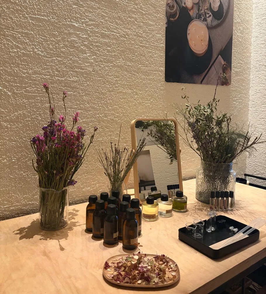 Aromatherapy setup with oils and dried flowers.