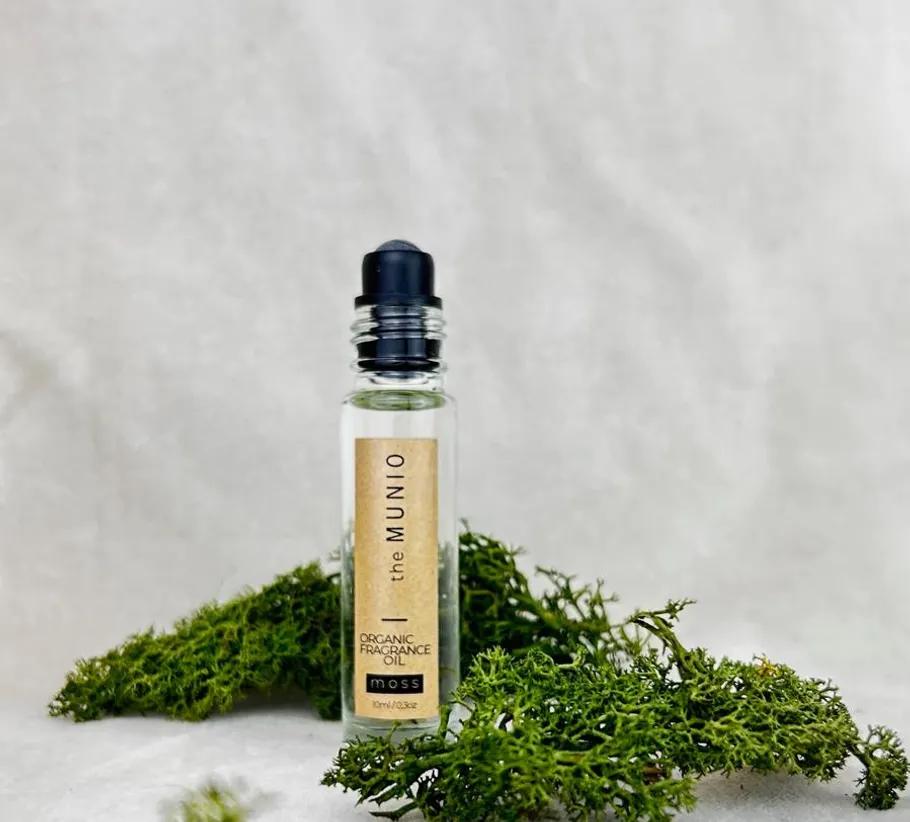 Fragrance oil bottle with surrounding moss.