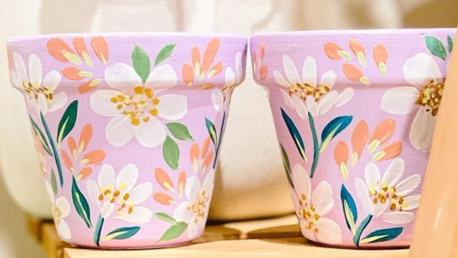 Painted flower pots with floral designs.