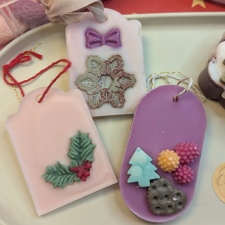 Decorative wax tablets with festive designs on plate.