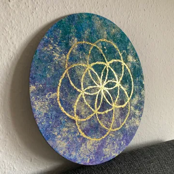 Round artwork with gold geometric pattern.