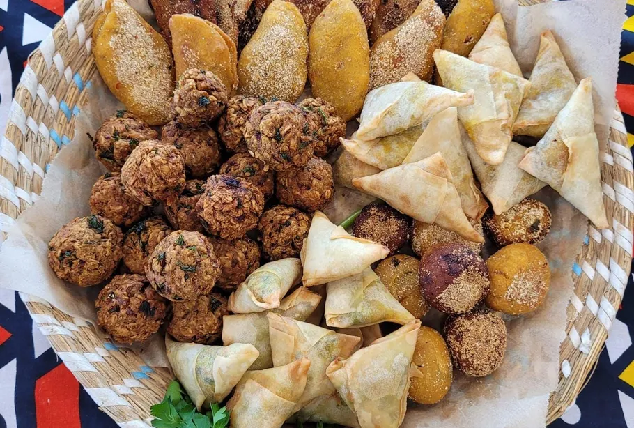 Assorted fried snacks in a woven basket.