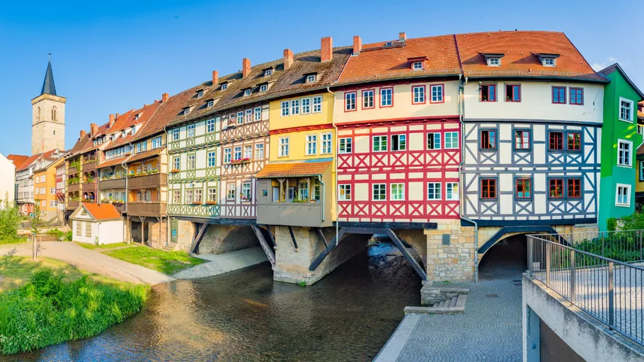 Colorful buildings on a bridge over river.